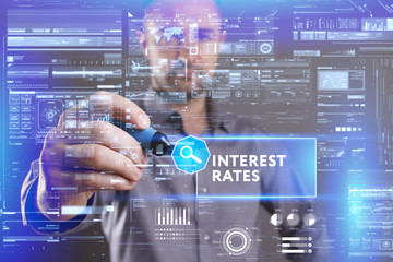 Business, Technology, Internet and network concept. Young businessman working on a virtual screen of the future and sees the inscription: Interest rates
