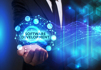 Business, Technology, Internet and network concept. Young businessman working on a virtual screen of the future and sees the inscription: Software development