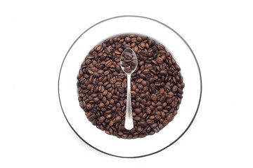 Plate with coffee beans over white background