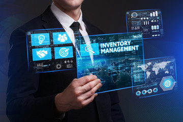 Business, Technology, Internet and network concept. Young businessman working on a virtual screen of the future and sees the inscription: Inventory management