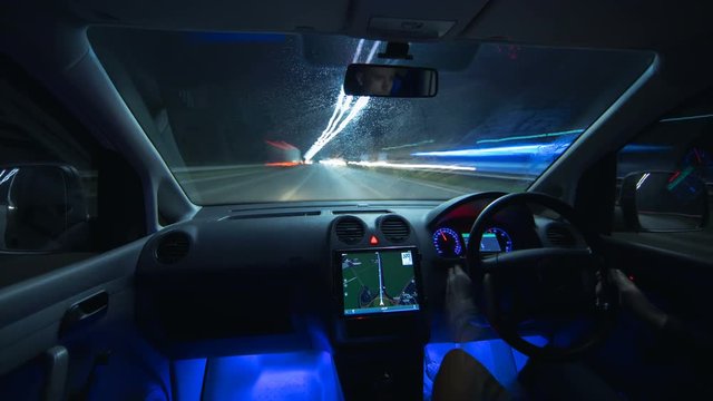 The man drive a car in the night city. Inside view. Hyperlapse. Wide angle