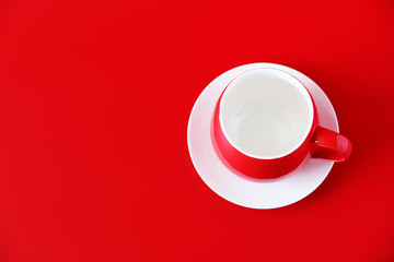 empty red color coffee cup on red top view.