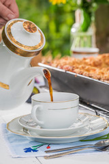 Homemade dessert with plum cake and coffee in summer
