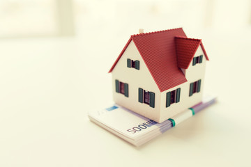 close up of home or house model and money