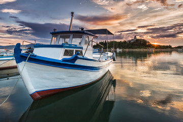 White fishing boat in the gulf at sunset