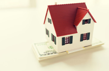 close up of home or house model and money