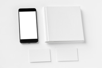 Brand identity mockup. Blank corporate stationery and gadget set at white textured paper background.