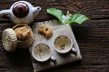 Jasmine tea and cookies on wooden table,Top view.