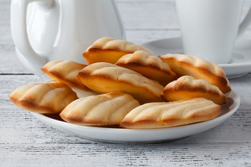 chocolate chip madeleines and coffee on a wooden board