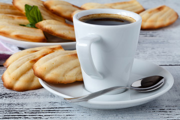 Homemade Madeleines / French Tea cake cookies served in a plate with cup of coffee