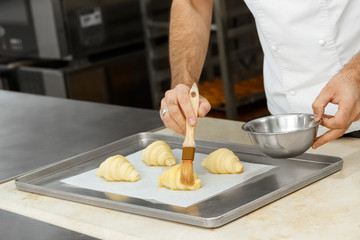 Professional pastry chef preparing croissants