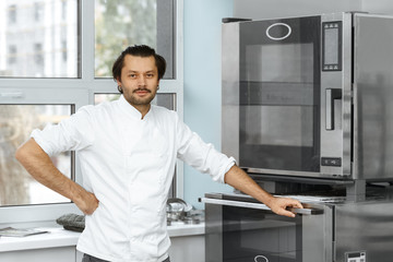 Handsome baker working at his bakery