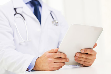 male doctor in white coat with tablet pc