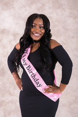 Portrait of a beautiful young African woman wearing a birthday sash
