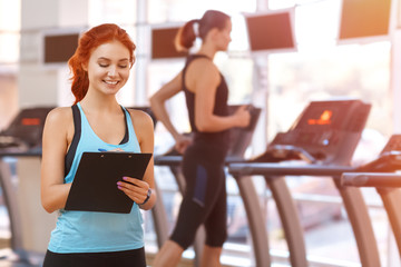 Female coach writing on a clipboard