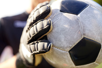 close up of goalkeeper with ball playing football