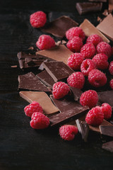 Dark and milk chopping chocolate and chips shavings chopping chocolate with fresh raspberries heap...