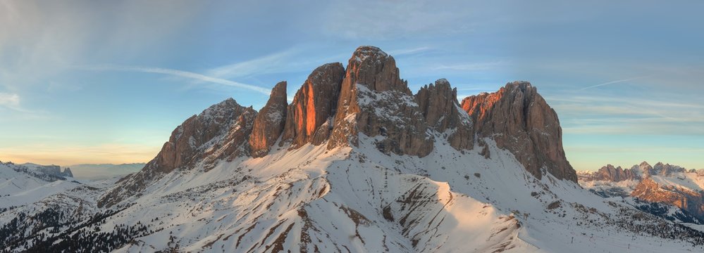 Sassolungo (German Langkofelgruppe) located between the Val Gardena and Val di Fassa in the Dolomites of Trentino-Alto Adige. Winter overview at sunset. Dolomites, Italy