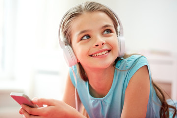 Naklejka premium close up of girl with smartphone and headphones