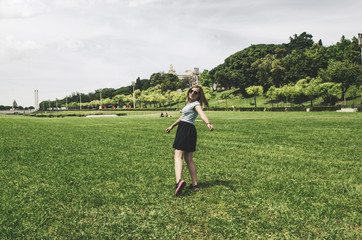 young happy woman running and having fun on grass