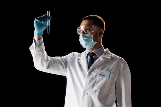 Scientist With Safety Glasses, Mask And Test Tube