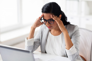 stressed businesswoman with laptop at office