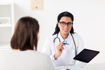 doctor with tablet pc and woman at hospital