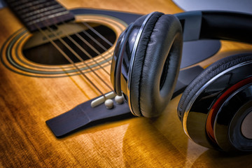Close Up shot headphone and acoustic guitar.