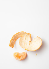 Mandarin slice with rind on white background