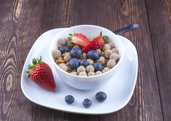 Healthy breakfast concept with oat flakes and fresh berries on r