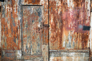 corroded rusty metal gate in rust  locked with security padlock