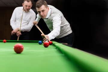 Game snooker billiards, athlete kick cue close up, selective focus