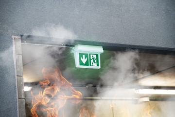 Emergency Fire Exit with smoke and fire flames
