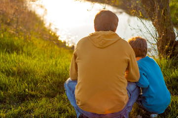 Father and son spend time together at the pond