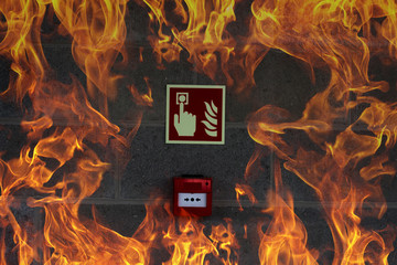 Emergency Fire Exit on the stone wall with fire flames