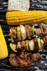 close on  meat with fruits and vegetables on the grill, top view