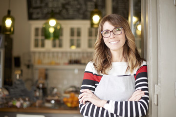 Proud cafe owner. Shot of a proud coffee shop owner businesswoman standing at doorway. Small business. 