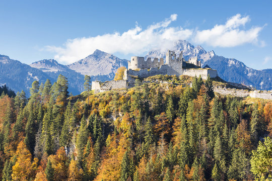 View of the old Ehrenberg Castle surrounded by colorful woods and rocky peaks, Reutte, Austria