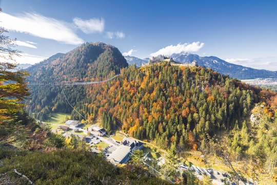 View of the old Ehrenberg Castle surrounded by colorful woods and suspension bridge, Highline 179, Reutte, Austria