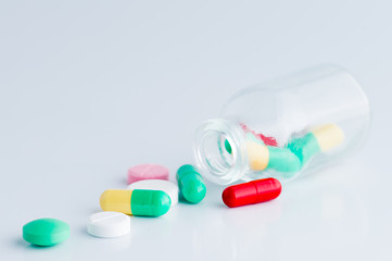 Medicine pills macro poured from a jar