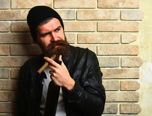 Bearded brutal caucasian hipster smoking cigar