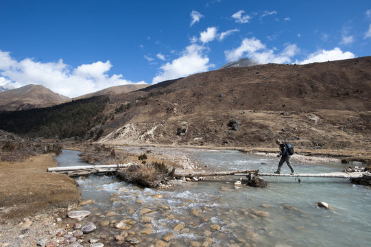 Trekking across a temporary bridge between Shomuthang and Robluthang on the Laya-Gasa trekking route, Gasa District, Bhutan