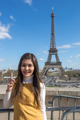 Woman touris tat the Eiffel tower in Paris, Famous popular touristic place in the world.