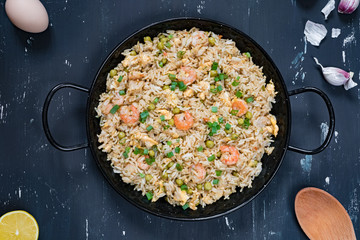 Fried rice with shrimp on the dark background