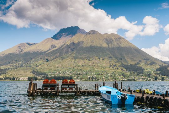 A pier and boat at the base of Volcan Imbabura and Lago San Pablo, close to the famous market town of Otovalo, Ecuador