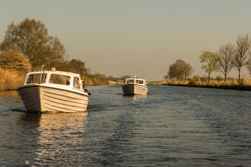 Fototapeta premium Typical motor boats on a canal in East Frisia