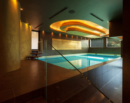 Swimming pool in a modern villa, nobody.
Covered pool