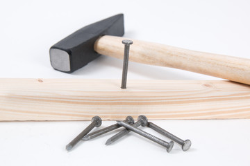 Hammer and building nails on white background.
