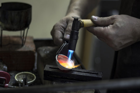 jeweler melts the metal -1