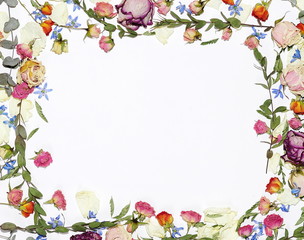  Frame from the pattern of dried flowers on a white wooden background.Top view.Copy space. 